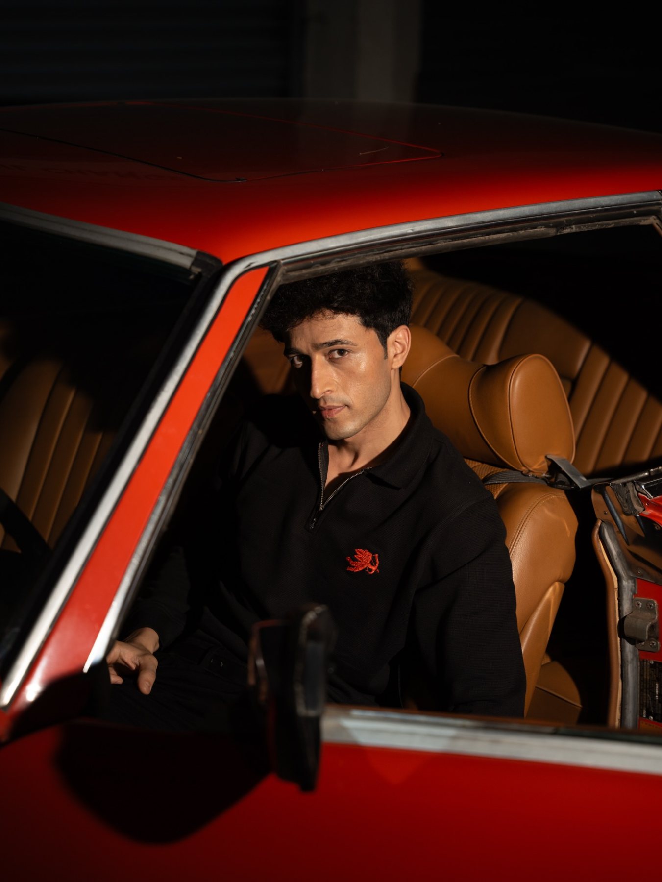 Raff photographed inside the red car
